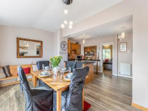 a dining room and living room with a table and chairs at Flyby Cottage in Symonds Yat