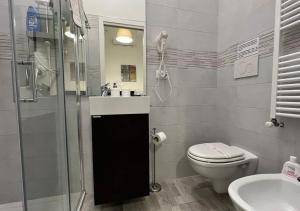 a bathroom with a toilet and a shower and a sink at La Maison in Acquaviva delle Fonti +11 photos
