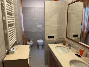 a bathroom with a toilet and a sink and a mirror at B&B PIAZZA KOLBE in Acquaviva delle Fonti +24 photos