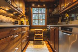 a kitchen with wooden cabinets and a ladder in it at Hellevi by Aavalevi in Levi