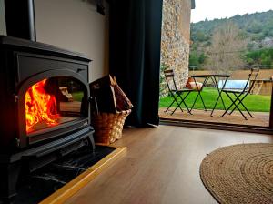 a fireplace in a room with a view of a patio at La Galiana loft nature in Casarejos