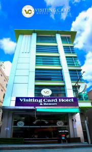 un edificio con un cartel en el costado en Visiting Card Hotel & Resort, en Bangkok