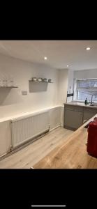 an empty room with a counter and a window at dyffryn cottage in Blaengawr