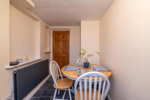 a small dining room with a table and chairs at Looe Self Catering in Looe
