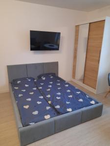 uma cama com um edredão azul num quarto em Welcome Cozy Apartment Old Town em Elblag