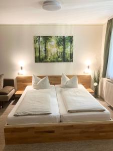 a bedroom with two beds and a couch at Pension Sonja Müller in Nohra