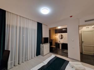 a hotel room with a bed and a large window at Art's Luxury Boutique Hotel in Oradea +41 photos