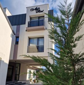 a building with a christmas tree in front of it at Art's Luxury Boutique Hotel in Oradea
