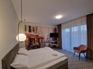 um quarto de hotel com uma cama e uma sala de estar em Art's Luxury Boutique Hotel em Oradea