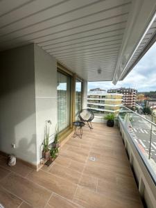 a balcony with a view of a building at A estrenar amplio con piscina y parking in Getxo