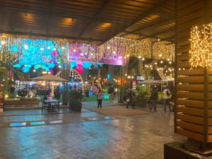 a shopping mall with christmas lights and people walking around at The Haven at One Eastwood Tower 1 in Manila