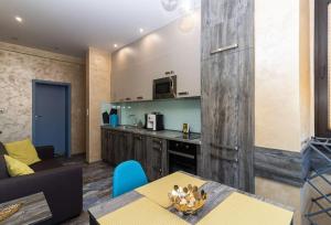 a living room with a table and a kitchen at Unique Central 1 Bedroom Flat in Sofia +5 photos