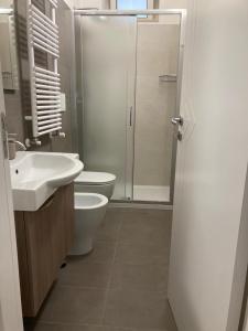 a bathroom with a shower and a toilet and a sink at Dimora Angolo15 in Cisternino +6 photos