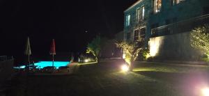 a building and a swimming pool at night at Casa Albelo do Gerês in Montalegre