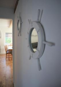 a mirror hanging on a wall in a room at Michówka in Mikoszewo