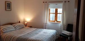 a bedroom with a bed and a window at Seven Stars- hot tub & garden with fabulous views. in Llandrindod Wells