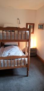 a bedroom with a bunk bed in a room at Seven Stars- hot tub & garden with fabulous views. in Llandrindod Wells