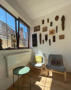 a living room with a table and a chair at Central Retro Apartment in Sibiu