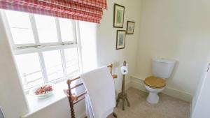 a bathroom with a toilet and a window at Ty Gwair in Pentraeth +61 photos