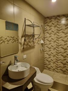 a bathroom with a sink and a toilet at Hotel Rey in Huancayo