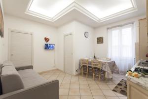 a living room with a couch and a table at Anzio- central holiday house. in Anzio