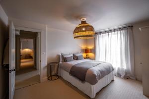 a bedroom with a bed and a large window at Number 27 by Big Skies Cottages in Holt