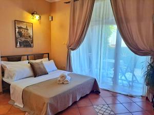 a bedroom with a bed and a large window at Leonarda in Crikvenica