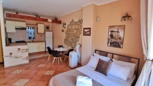 a bedroom with a bed and a kitchen and a table at Leonarda in Crikvenica