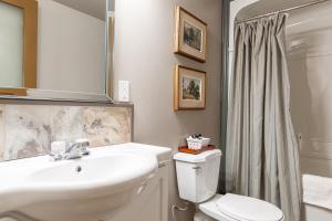 a bathroom with a sink and a toilet and a shower at Henry House - Patio Suite - An Arrivals Stay in Stratford