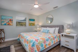 a bedroom with a bed and a ceiling fan at Avenida Sanctuary in Siesta Key +47 photos