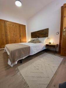 a bedroom with a large bed and a table at SINA - El Tarter in El Tarter