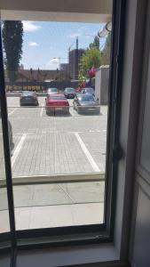 a view from a window of a parking lot with cars at 21 Residence Apartments in Bucharest