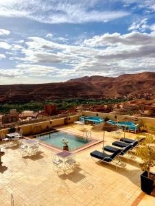 a resort with a pool and mountains in the background at Ksar Sultan Dades - Dades Valley Retreat in Boumalne Dades