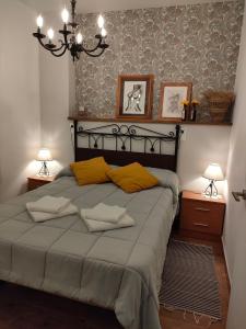 a bedroom with a large bed with yellow pillows at Apartamento Lauria centro in Ronda