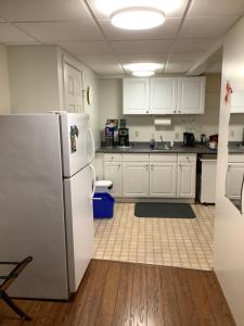 a kitchen with white cabinets and a refrigerator at Bear Cub Lodging in Jasper