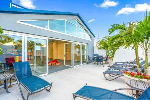 a patio with blue chairs and tables and windows at Fenwick Inn in Ocean City