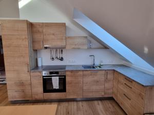 a kitchen with wooden cabinets and a blue counter top at lovely apartment 