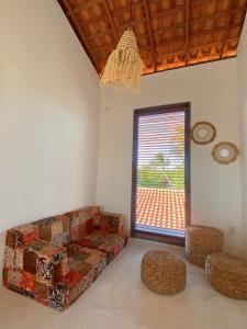 a living room with a couch and a window at Casa Nature Atins in Atins