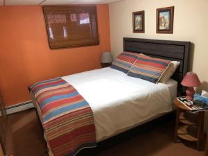 a bedroom with a large white bed and a window at Bear Cub Lodging in Jasper