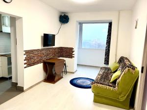 a living room with a couch and a tv at Fantastic View on Chisinau Center - Super Fast WiFi - Two Botanical Gardens - 2BR in Chişinău
