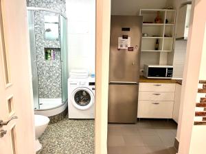 a kitchen with a refrigerator and a washing machine at Fantastic View on Chisinau Center - Super Fast WiFi - Two Botanical Gardens - 2BR in Chişinău