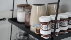 a shelf with many jars of peanut butter at F&E - gemütliche & zentrumsnahe Unterkunft in Esslingen