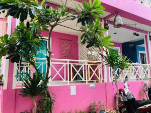 a pink house with palm trees in front of it at HappyLove1 in Ko Larn