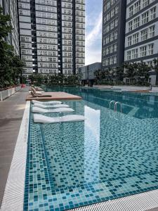 a swimming pool with a table and some buildings at SUWAN Guesthouse A07 - 2BR Apartment with Free Wifi Near Kajang 2 in Kajang