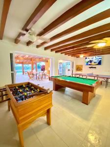 a living room with a pool table and ping pong balls at Hostería del Parque in Machalilla