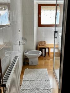 a bathroom with a toilet and a sink at Maison de village avec vue sur les montagnes et jardin privatif in Montauban-de-Luchon