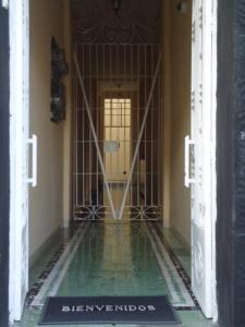 a hallway with a gate and a room with a pool of water at Hotel Suites Córdoba in Córdoba