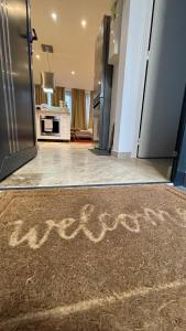 a kitchen with an open door with the word kitchen written on the floor at By nuit-parisienne : Superbe appartement avec SPA et terrasse privée in Villemomble