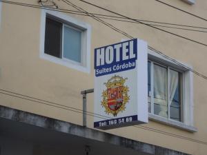 a sign for a hotel on the side of a building at Hotel Suites Córdoba in Córdoba