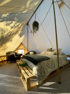 a bedroom with a bed in a tent at Viewpoint Country Glamping in Great Western